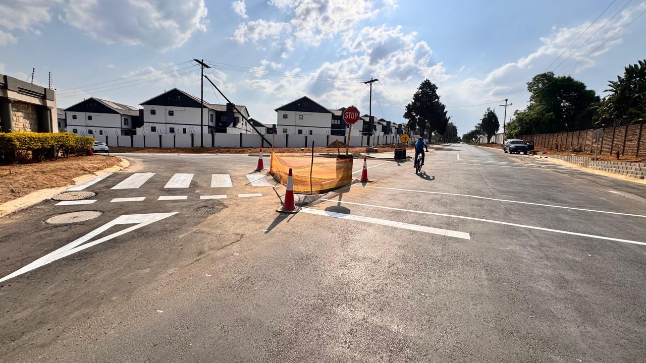 Cyclist using the completed upgraded road at Waterfall Manor