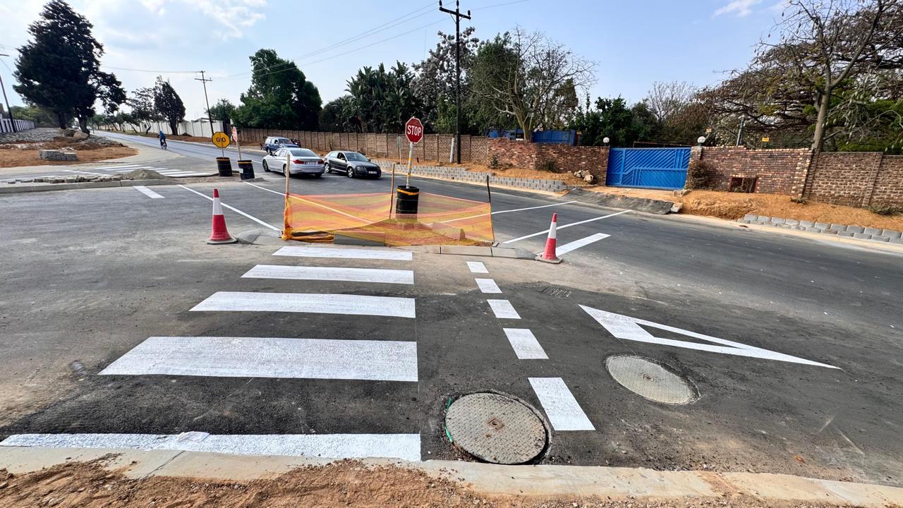 Pedestrian crossings and manhole covers on the completed road