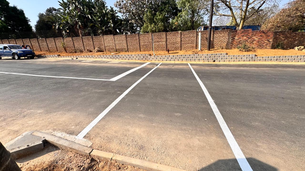 Fresh road markings and retaining wall alongside the new surface