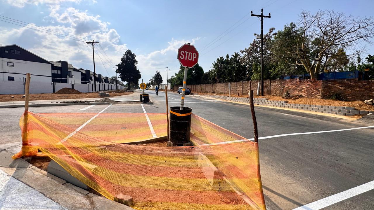 Completed road with signage and traffic islands at Waterfall Manor