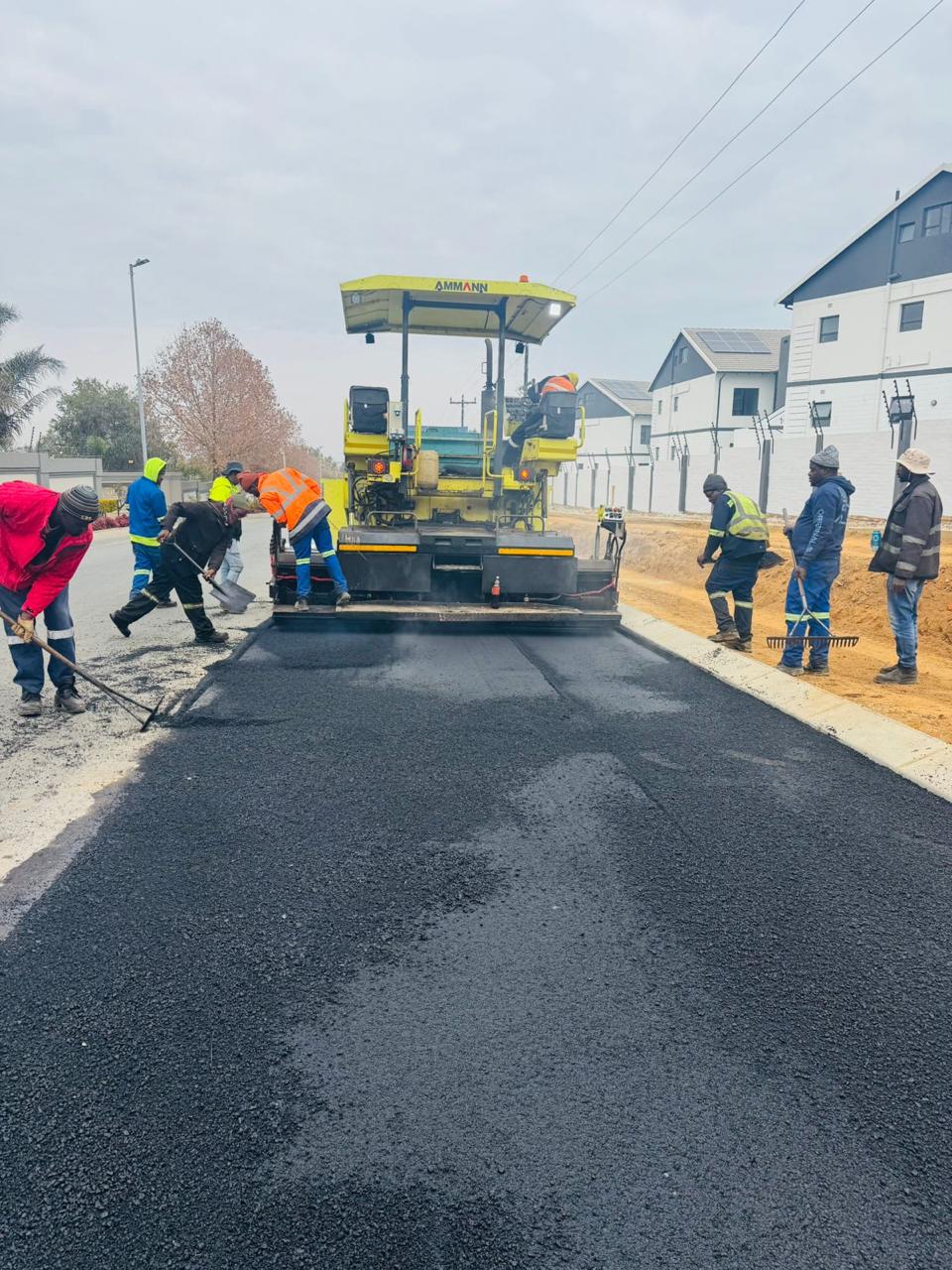 Asphalt paver laying the new road surface at Waterfall Manor